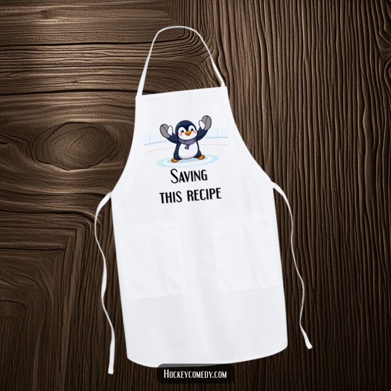 Funny penguin goalie apron showing a comical, exaggerated hockey save, ideal for kitchen use and adding humor to cooking tasks.