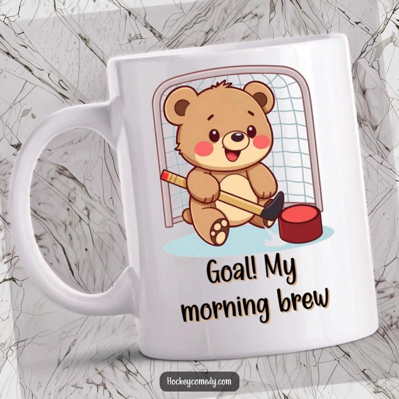 Funny mug featuring a happy bear cub playfully swatting a hockey puck towards a net with determined enthusiasm.