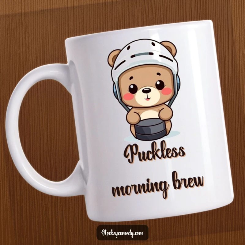 Funny small bear in a hockey helmet comically misses a puck on this humorous sports mug.