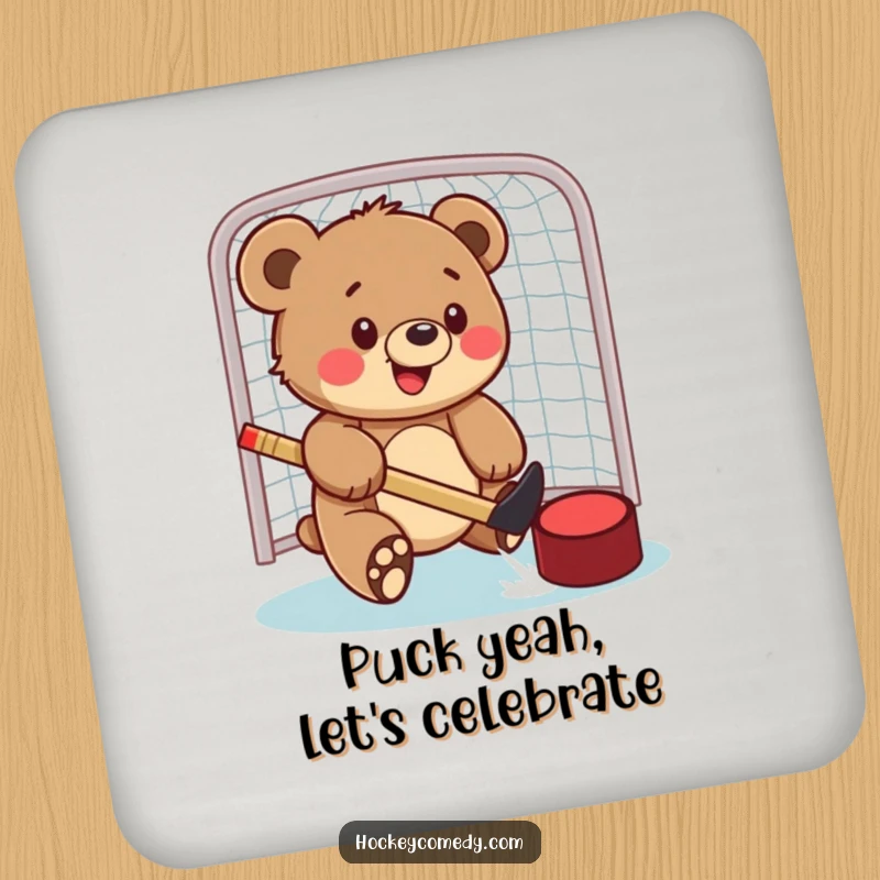 Funny drink coaster featuring a bear cub playfully swatting a hockey puck into a net, bringing a sporty theme to any surface.