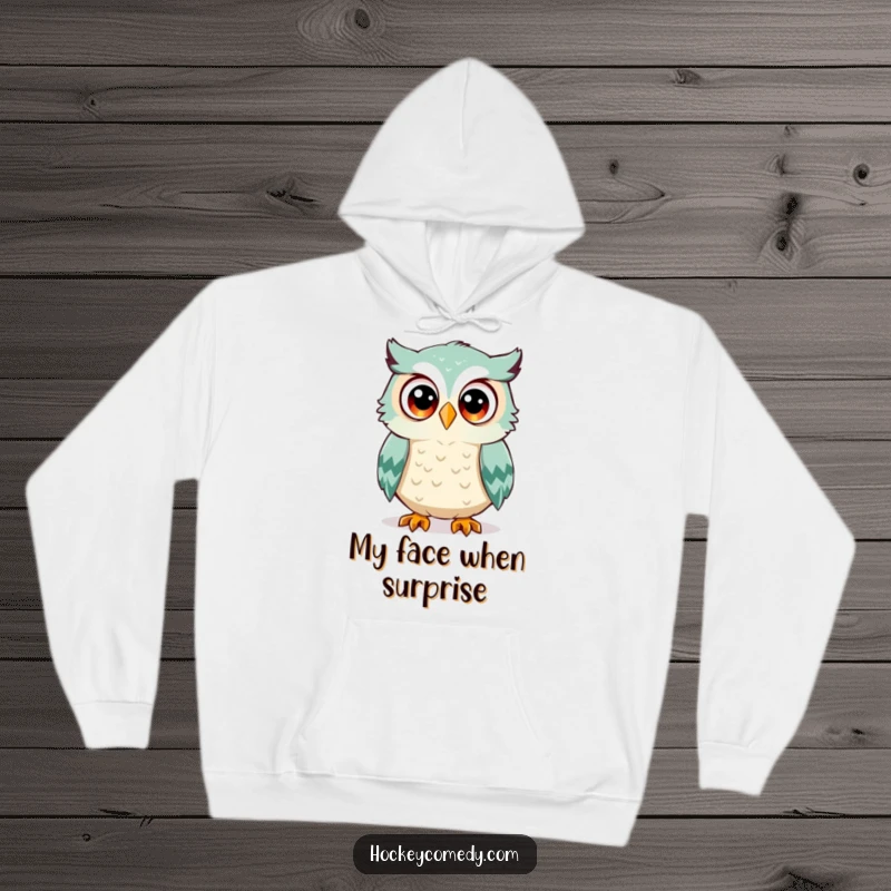 Funny owl hoodie, a surprised owl with wide eyes, about to be hit by a hockey puck, offering warmth and humor, great gift.