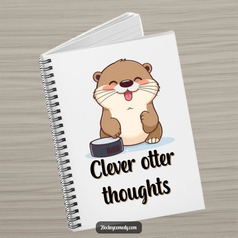 Funny cheerful otter trying to catch a hockey puck with its nose on the cover of a humorous notebook.