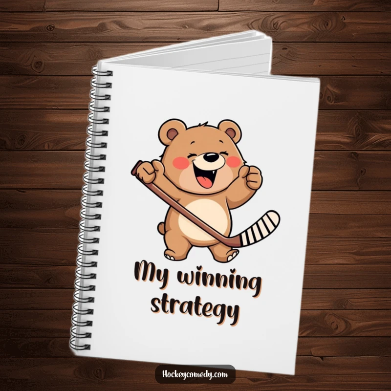 Funny notebook with a happy, roaring bear furiously waving a hockey stick, perfect for jotting down ideas and plans.