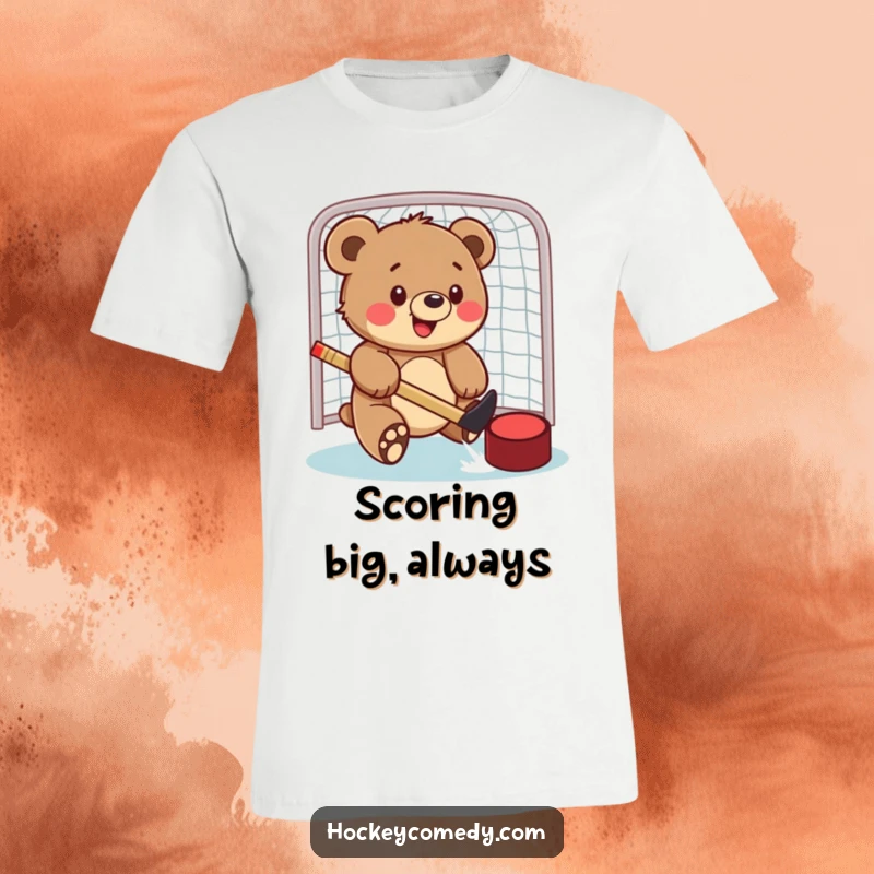 Funny t-shirt depicting a cheerful bear cub in the act of playfully swatting a hockey puck into a goal, full of sporting spirit.