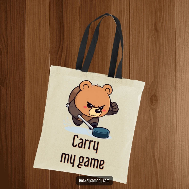 Funny Bear Tote Bag: An aggressive bear with a determined glare, chasing a hockey puck, perfect for carrying sports gear. Great funny gift.