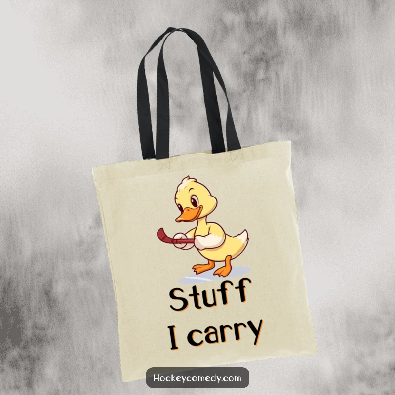 Funny tote bag: A duck tries a slap shot, wobbling comically on the ice, a humorous depiction of athletic effort.