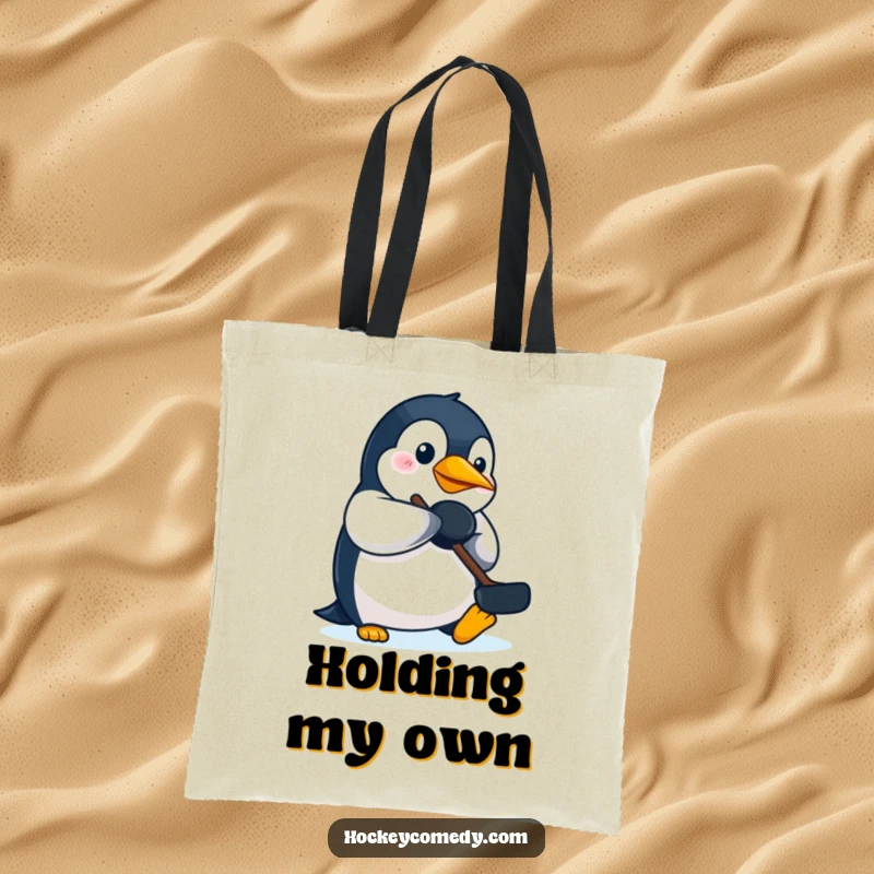Funny penguin hockey tote bag, with a focused penguin batting a puck using its beak, great for fans.
